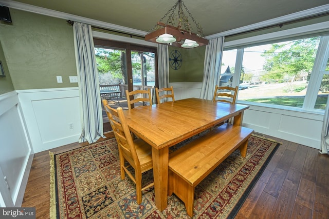 dining area with dark hardwood / wood-style flooring and ornamental molding