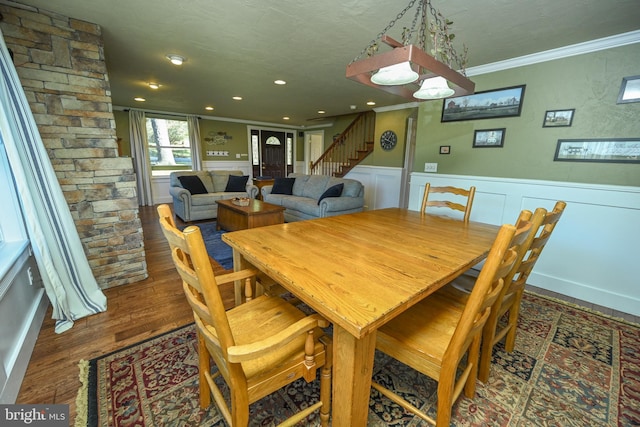 dining room featuring dark hardwood / wood-style flooring and crown molding