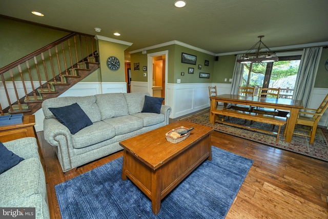 living room with dark wood-type flooring and crown molding