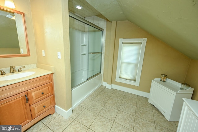 bathroom featuring vanity, tile patterned flooring, vaulted ceiling, and combined bath / shower with glass door