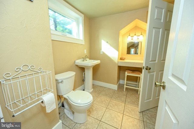 bathroom with tile patterned flooring, sink, and toilet