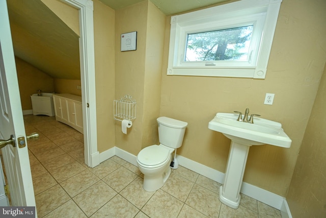 bathroom with tile patterned flooring, sink, and toilet