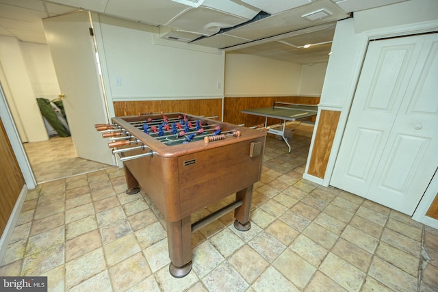 game room with wooden walls