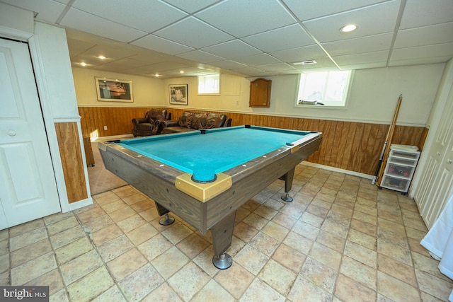 game room with pool table, a drop ceiling, and wood walls