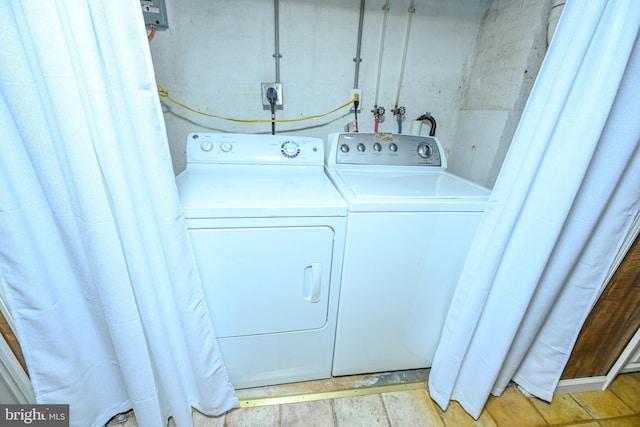 clothes washing area featuring separate washer and dryer