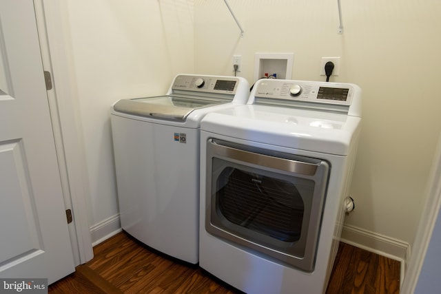 washroom featuring dark hardwood / wood-style floors and washing machine and clothes dryer