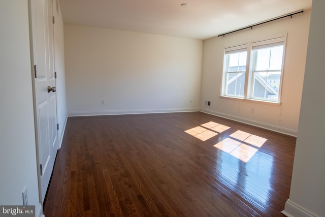 spare room featuring dark hardwood / wood-style floors