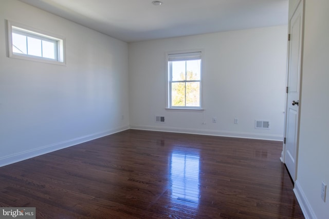 spare room featuring dark hardwood / wood-style floors