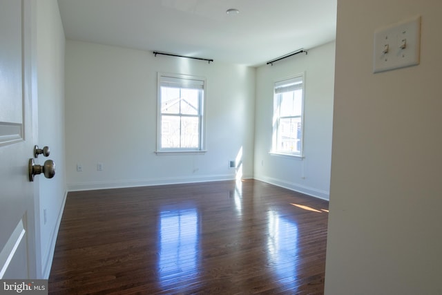 unfurnished room featuring dark wood-type flooring