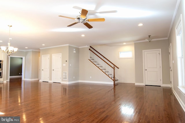 unfurnished living room with ornamental molding, ceiling fan with notable chandelier, plenty of natural light, and dark hardwood / wood-style flooring