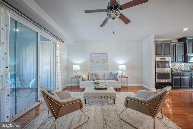 living room featuring hardwood / wood-style flooring and ceiling fan