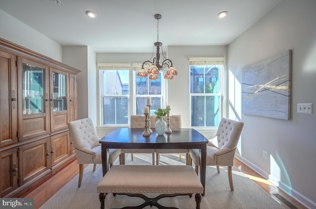 dining area featuring light hardwood / wood-style floors and a healthy amount of sunlight