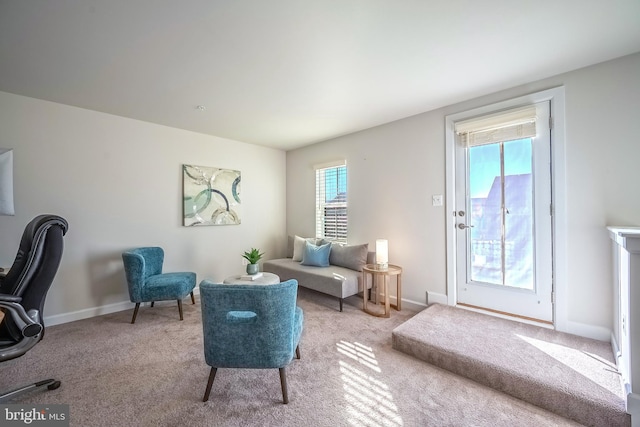 living area with light carpet and plenty of natural light