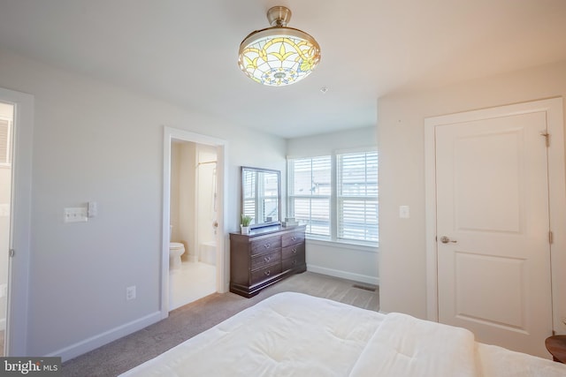 carpeted bedroom featuring ensuite bathroom