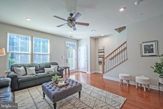 living room featuring hardwood / wood-style flooring and ceiling fan