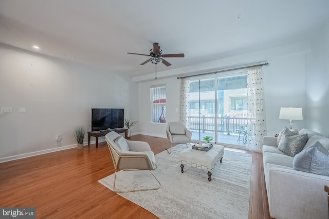 living room with ceiling fan and hardwood / wood-style floors