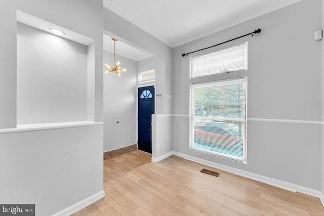 entryway featuring a notable chandelier and hardwood / wood-style flooring