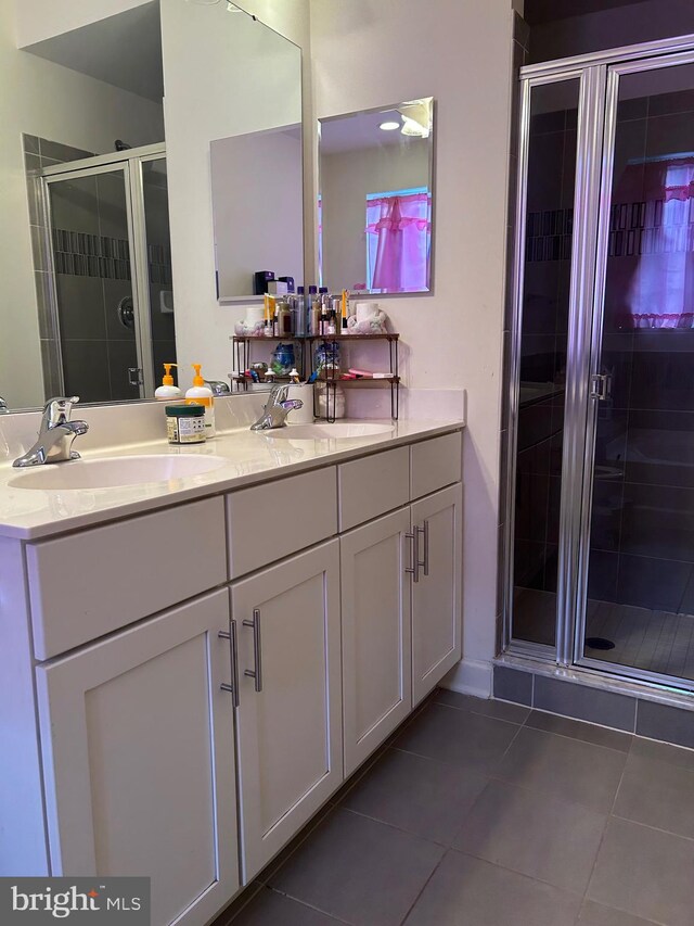 bathroom with tile patterned floors, vanity, and a shower with shower door