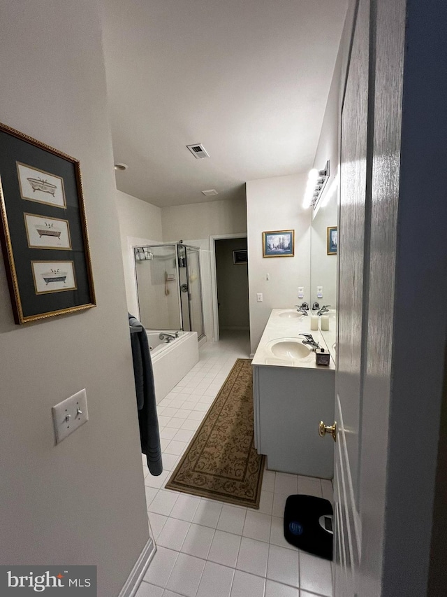 bathroom featuring tile patterned flooring, vanity, and combined bath / shower with glass door