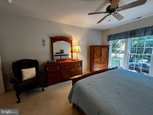 bedroom with ceiling fan and light carpet