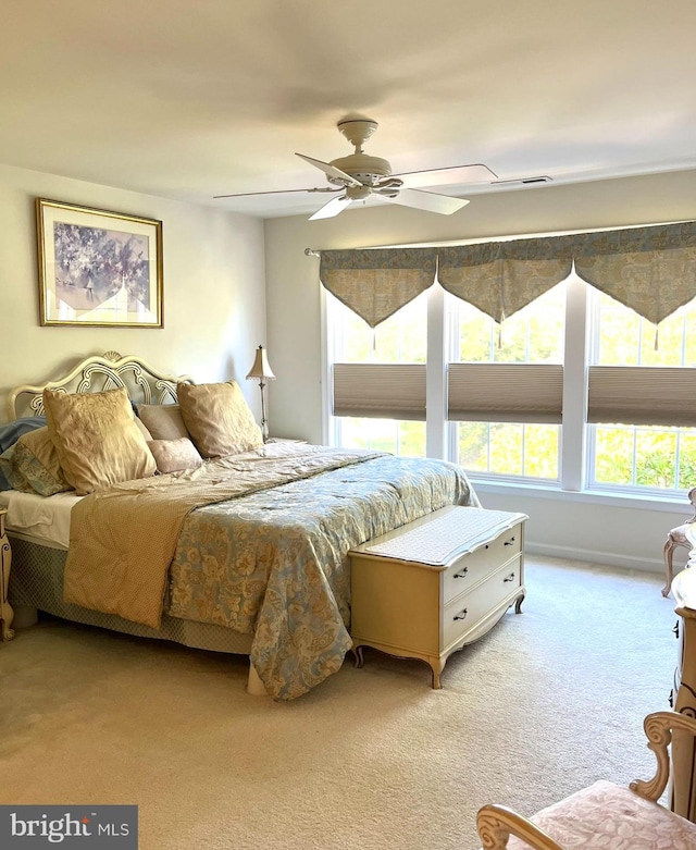 bedroom with light colored carpet and ceiling fan