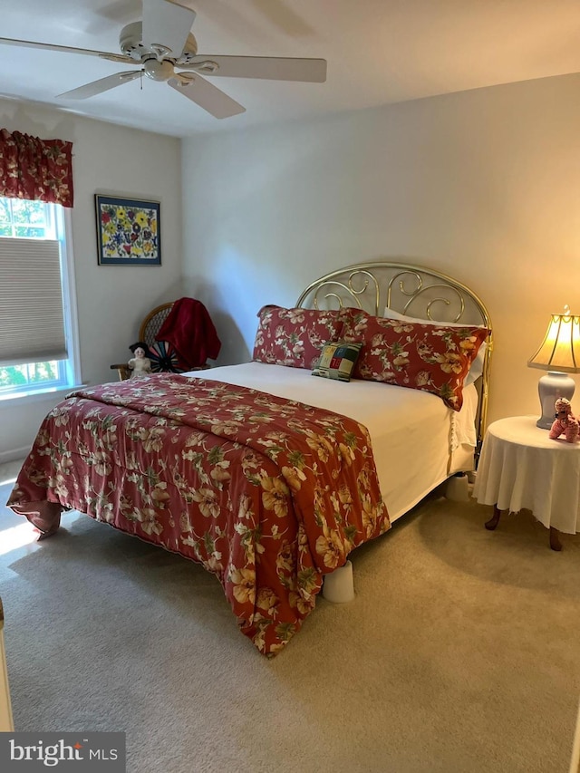 bedroom featuring ceiling fan and carpet