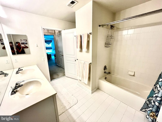 bathroom with tile patterned flooring, vanity, and shower / tub combo