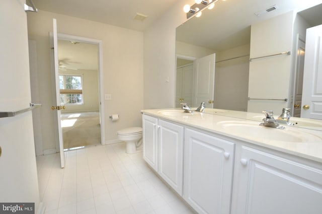 bathroom with ceiling fan, tile patterned flooring, vanity, and toilet