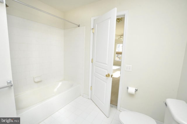 bathroom featuring shower / bathing tub combination and toilet