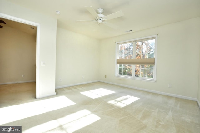 empty room featuring light carpet and ceiling fan