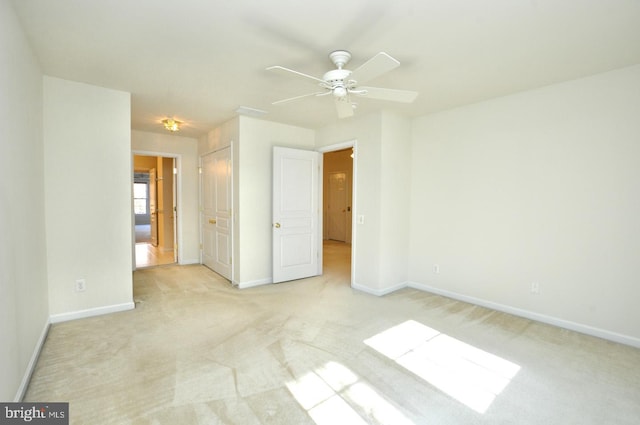 unfurnished bedroom with ceiling fan and light carpet