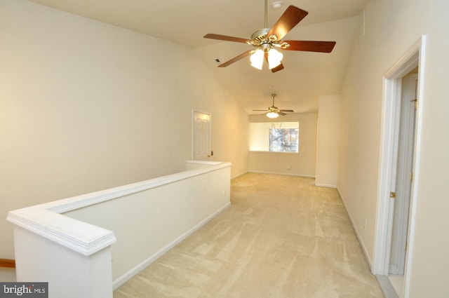 hallway featuring light colored carpet and high vaulted ceiling