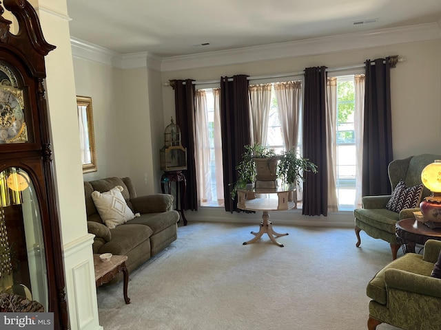 carpeted living room with ornamental molding