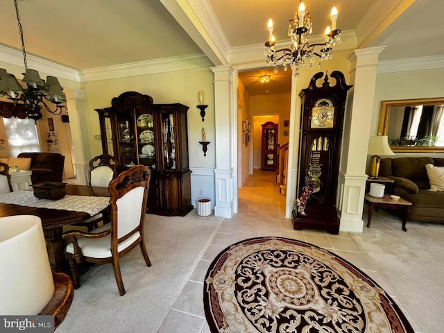 dining space featuring ornate columns, crown molding, a chandelier, and light carpet