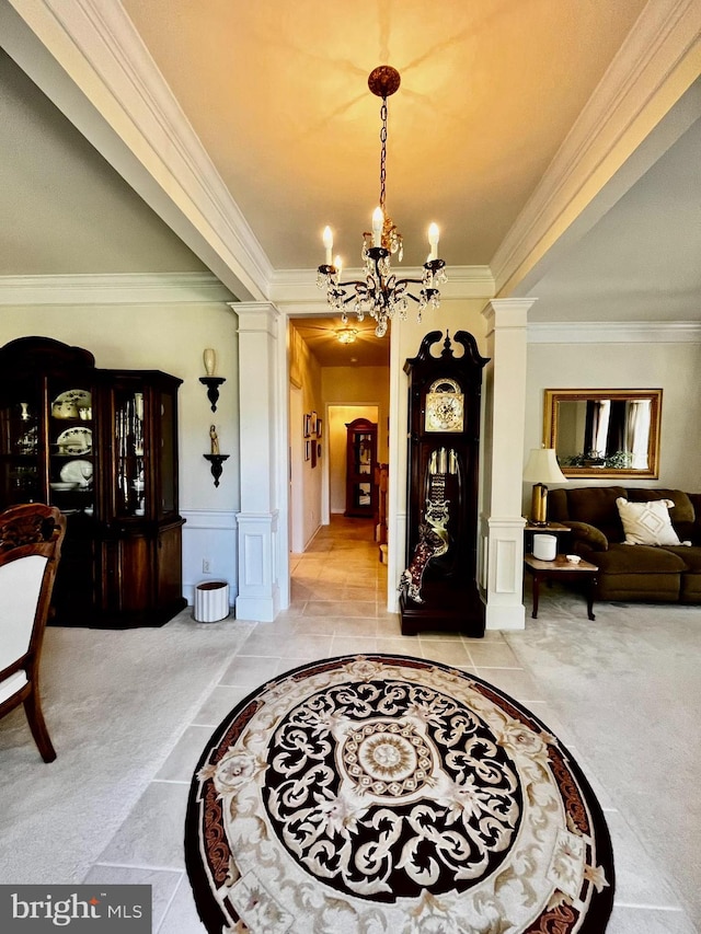 interior space with a notable chandelier, ornate columns, and crown molding