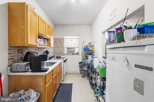 kitchen featuring cooling unit, sink, and white gas range oven