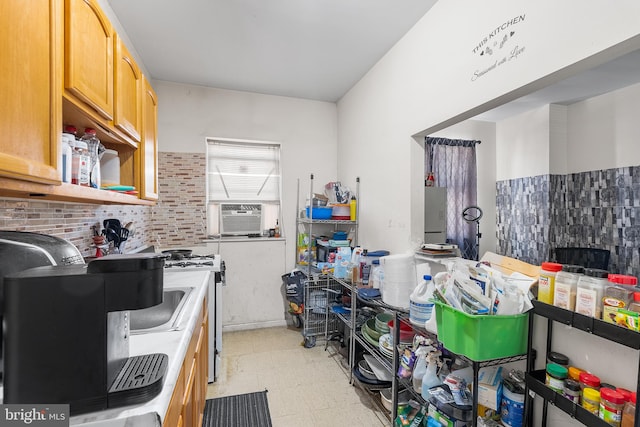 kitchen featuring cooling unit, a fireplace, and white range with gas cooktop