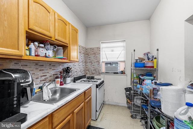 kitchen featuring sink, cooling unit, white range with gas stovetop, and backsplash