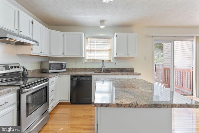 kitchen with appliances with stainless steel finishes, sink, light wood-type flooring, and white cabinetry