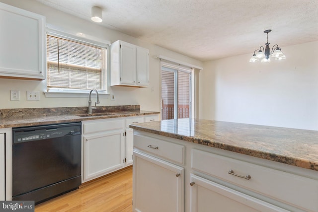 kitchen with sink, light hardwood / wood-style floors, black dishwasher, white cabinetry, and a chandelier