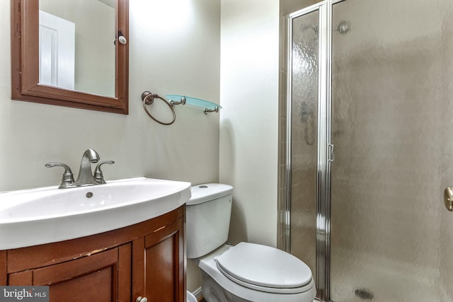 bathroom with vanity, toilet, and an enclosed shower