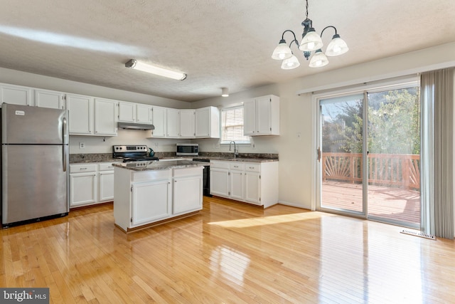 kitchen featuring white cabinets, appliances with stainless steel finishes, and plenty of natural light