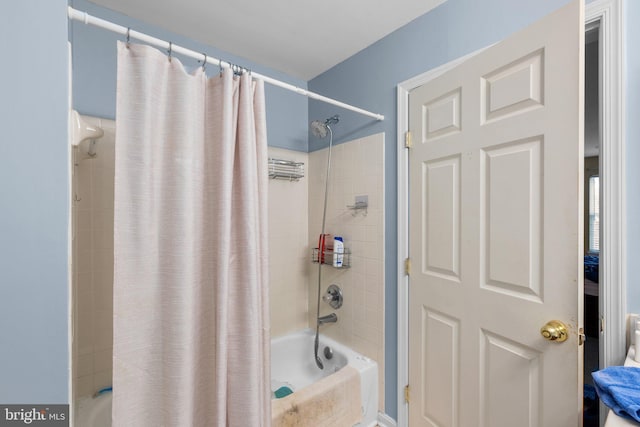 bathroom with shower / bath combination with curtain