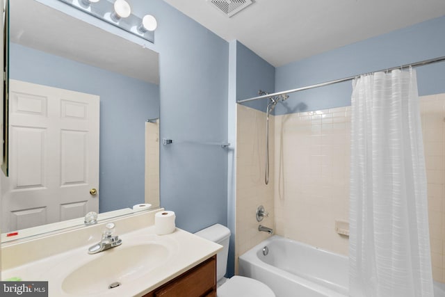 full bathroom featuring vanity, shower / tub combo with curtain, and toilet