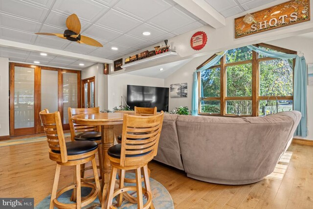 dining space with light wood-type flooring and ceiling fan