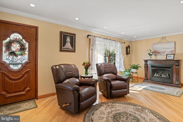 living room with light hardwood / wood-style floors and ornamental molding