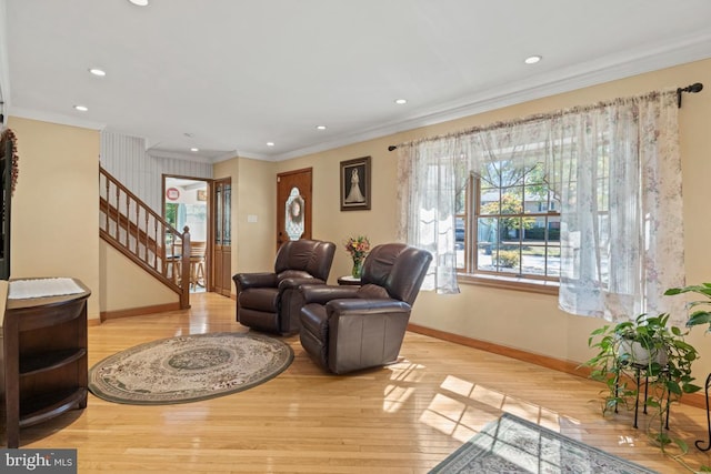 living room with ornamental molding and light wood-type flooring