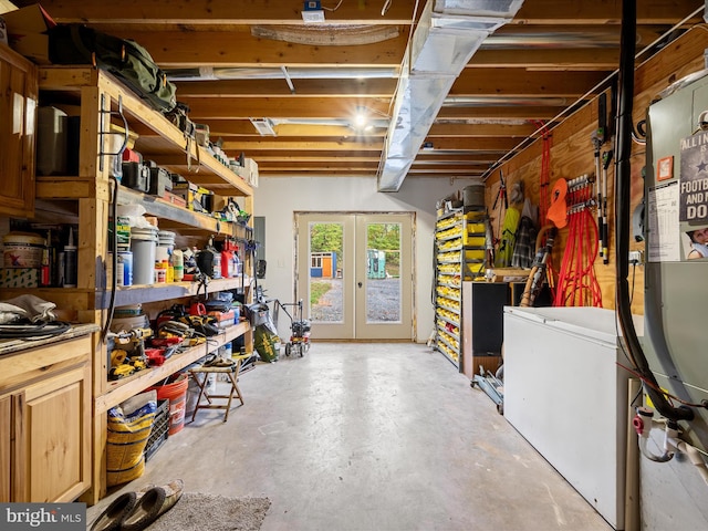 basement featuring french doors, a workshop area, and fridge