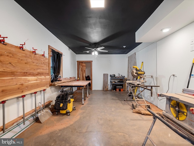 basement featuring a workshop area and ceiling fan