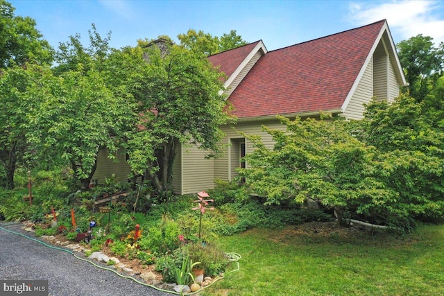 view of side of property with a lawn